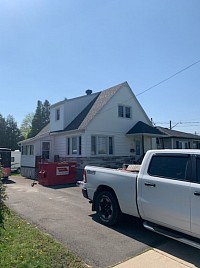 Roof Transformation – Massena & Akwesasne This image shows a roof before and after Garlow Roofing completed a full replacement, transforming worn, damaged shingles into a durable, high-quality roof built to last.